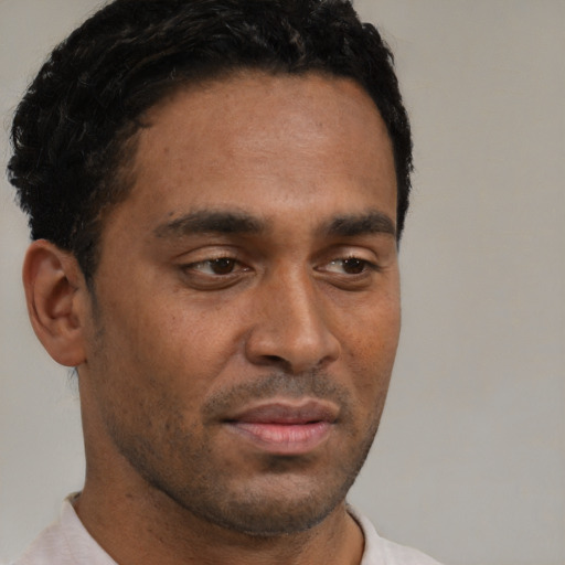 Neutral black young-adult male with short  black hair and brown eyes