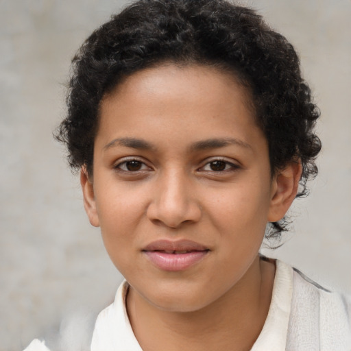 Joyful latino young-adult female with short  brown hair and brown eyes