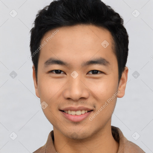 Joyful asian young-adult male with short  black hair and brown eyes