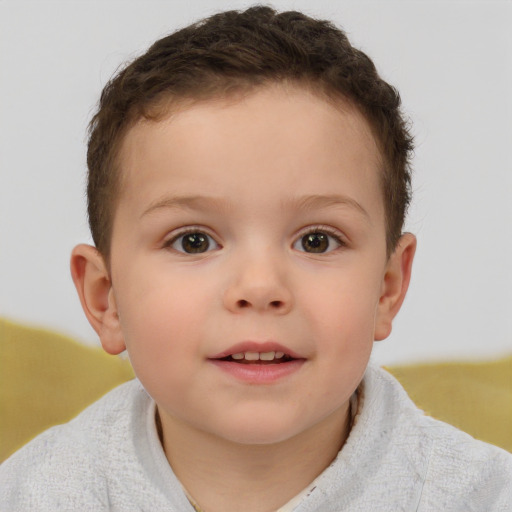 Joyful white child male with short  brown hair and brown eyes