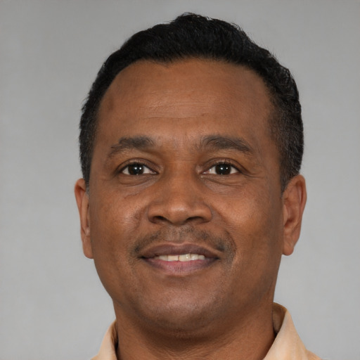 Joyful black adult male with short  black hair and brown eyes