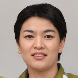 Joyful asian young-adult female with short  black hair and brown eyes