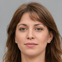 Joyful white young-adult female with long  brown hair and grey eyes