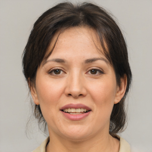 Joyful asian adult female with medium  brown hair and brown eyes