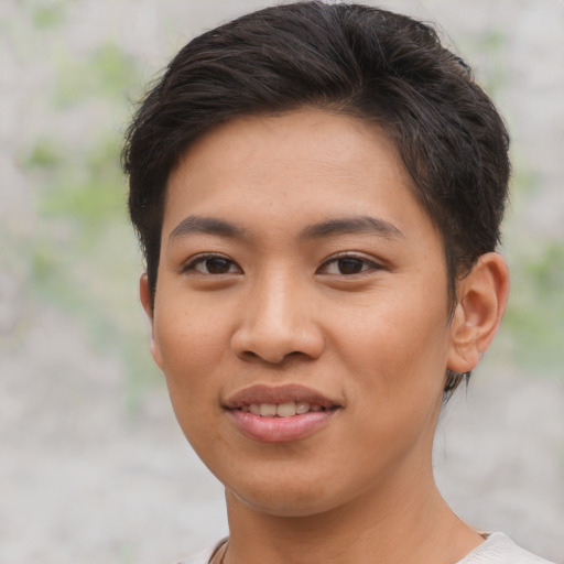 Joyful asian young-adult female with short  brown hair and brown eyes