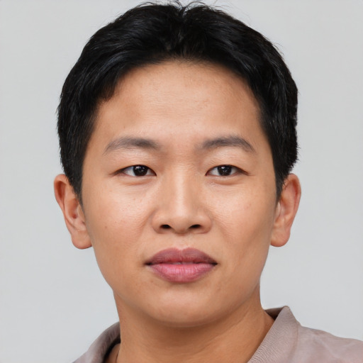 Joyful asian young-adult male with short  black hair and brown eyes