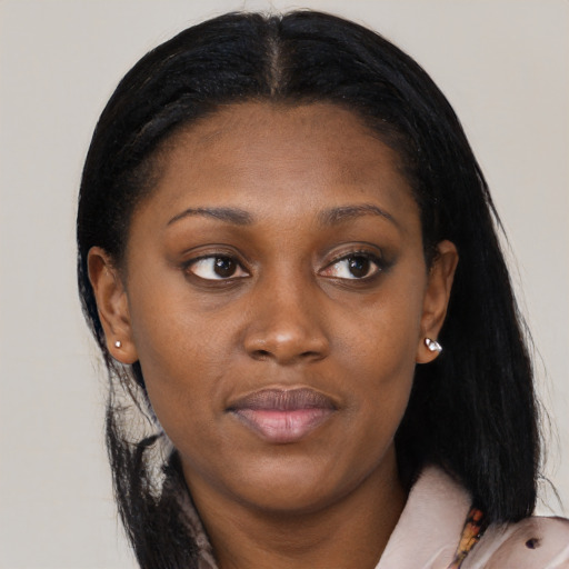 Joyful black young-adult female with long  black hair and brown eyes