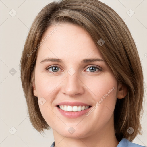 Joyful white young-adult female with medium  brown hair and green eyes