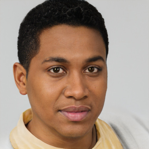 Joyful latino young-adult male with short  brown hair and brown eyes