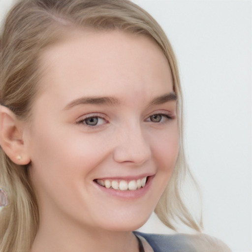 Joyful white young-adult female with long  blond hair and blue eyes