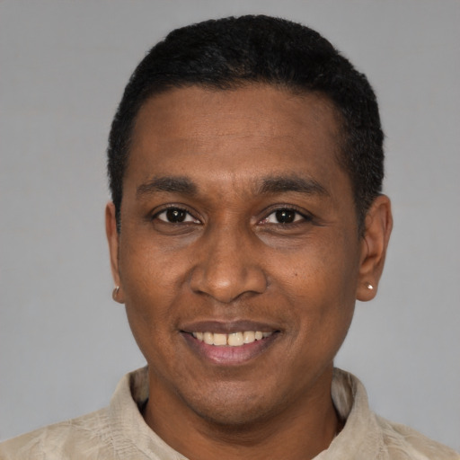 Joyful latino adult male with short  black hair and brown eyes