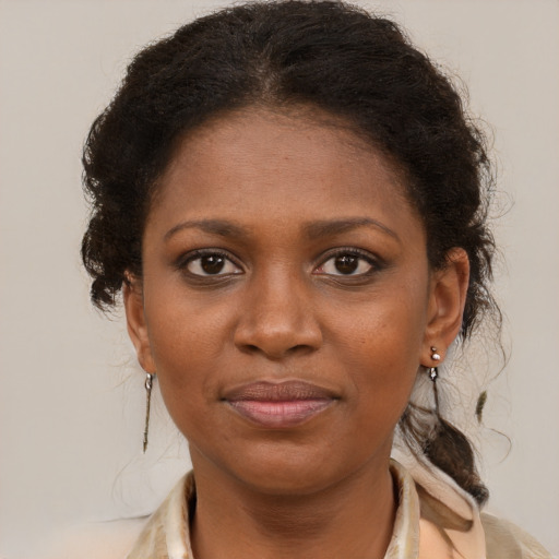 Joyful black young-adult female with medium  brown hair and brown eyes