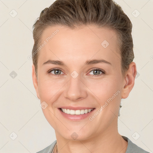 Joyful white young-adult female with short  brown hair and grey eyes