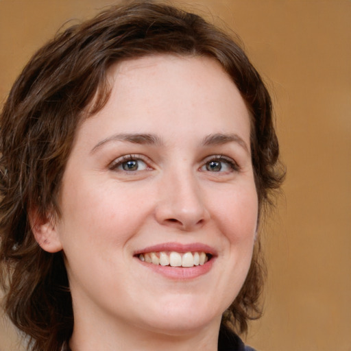 Joyful white young-adult female with medium  brown hair and green eyes