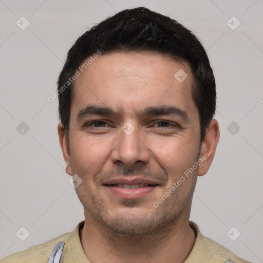 Joyful white young-adult male with short  black hair and brown eyes