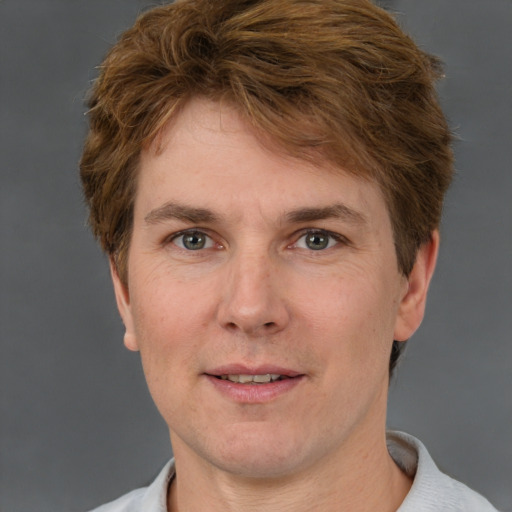 Joyful white adult male with short  brown hair and grey eyes