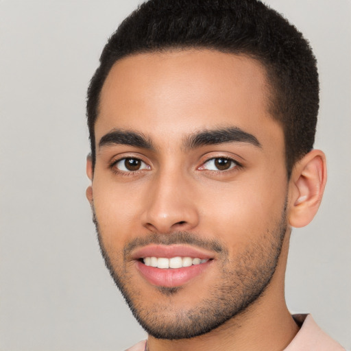 Joyful latino young-adult male with short  black hair and brown eyes