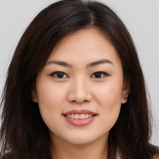 Joyful white young-adult female with long  brown hair and brown eyes