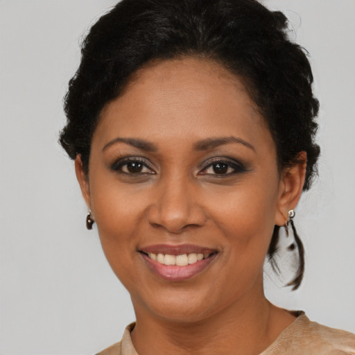 Joyful black adult female with short  brown hair and brown eyes