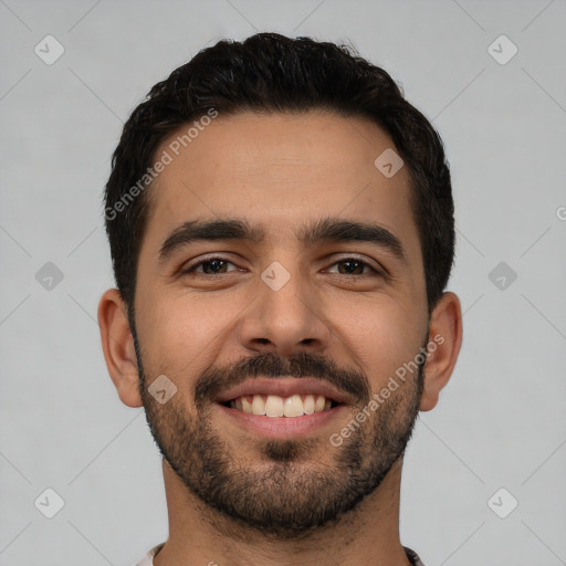 Joyful white young-adult male with short  black hair and brown eyes