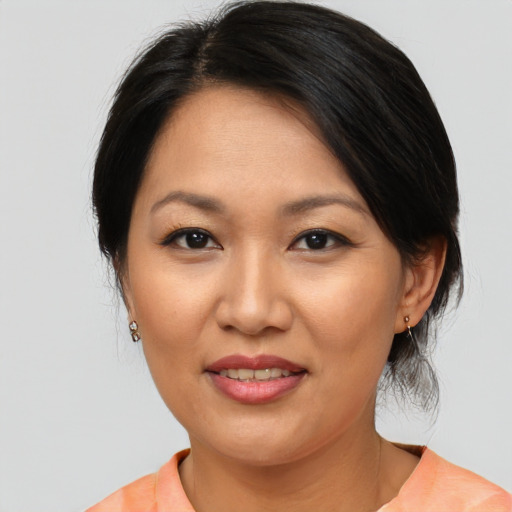 Joyful asian adult female with medium  brown hair and brown eyes