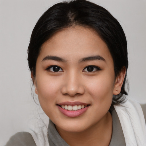 Joyful asian young-adult female with medium  brown hair and brown eyes