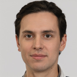 Joyful white young-adult male with short  brown hair and grey eyes