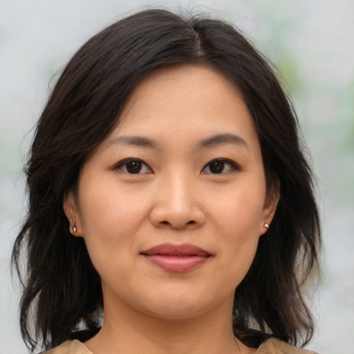 Joyful asian young-adult female with medium  brown hair and brown eyes