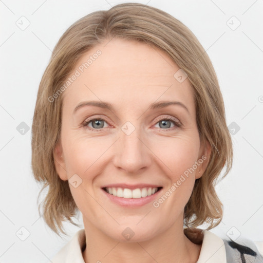 Joyful white young-adult female with medium  brown hair and blue eyes