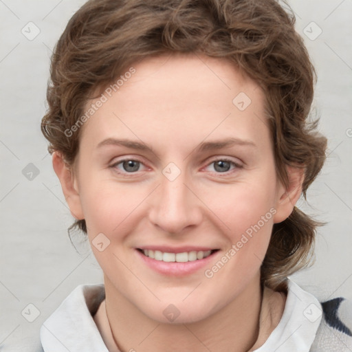 Joyful white young-adult female with medium  brown hair and blue eyes