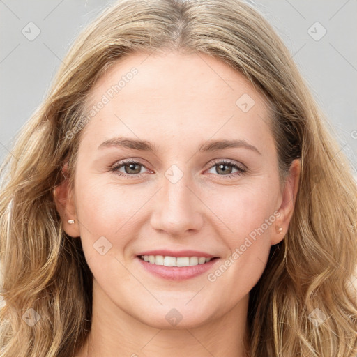 Joyful white young-adult female with long  brown hair and blue eyes