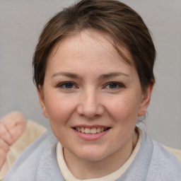 Joyful white young-adult female with medium  brown hair and blue eyes