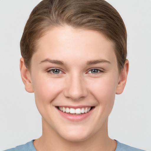 Joyful white young-adult female with short  brown hair and grey eyes