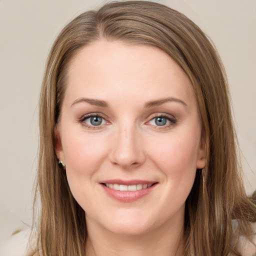 Joyful white young-adult female with long  brown hair and grey eyes