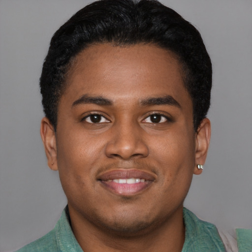 Joyful black young-adult male with short  brown hair and brown eyes