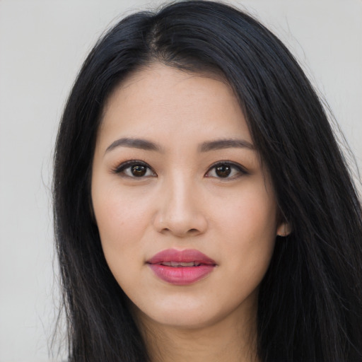 Joyful asian young-adult female with long  black hair and brown eyes