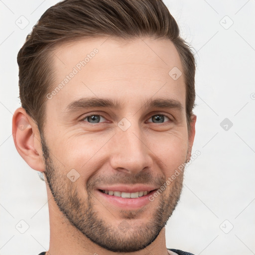 Joyful white young-adult male with short  brown hair and grey eyes