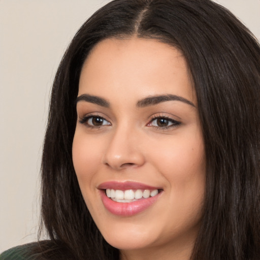 Joyful white young-adult female with long  black hair and brown eyes