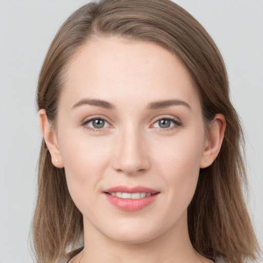 Joyful white young-adult female with long  brown hair and grey eyes