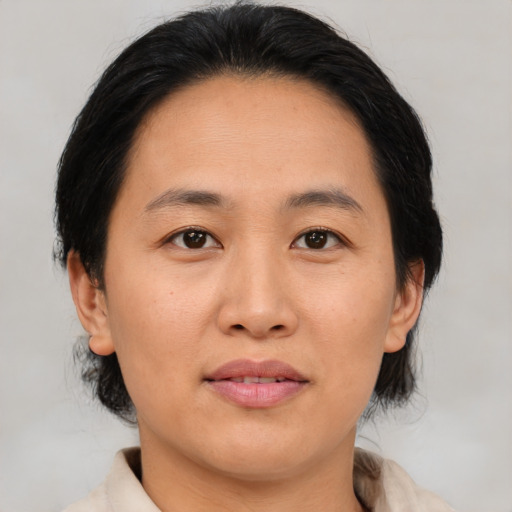 Joyful asian adult female with medium  brown hair and brown eyes