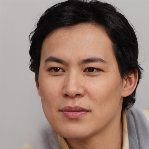 Joyful asian young-adult male with medium  brown hair and brown eyes