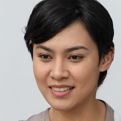 Joyful asian young-adult female with medium  black hair and brown eyes