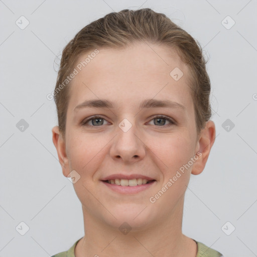 Joyful white young-adult female with short  brown hair and grey eyes