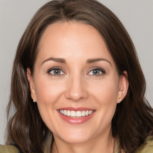 Joyful white young-adult female with medium  brown hair and brown eyes