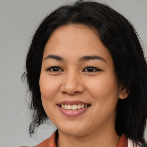 Joyful asian young-adult female with medium  brown hair and brown eyes