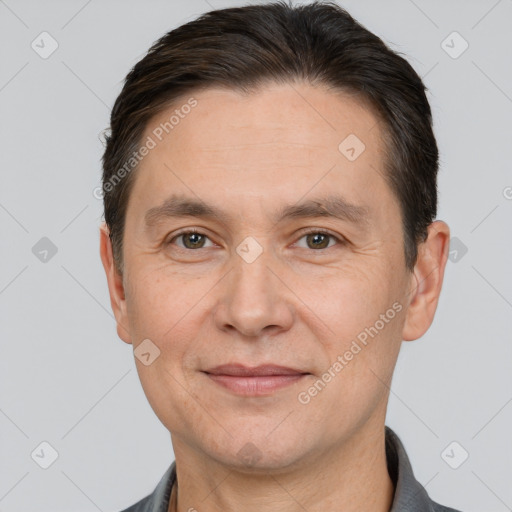 Joyful white adult male with short  brown hair and brown eyes