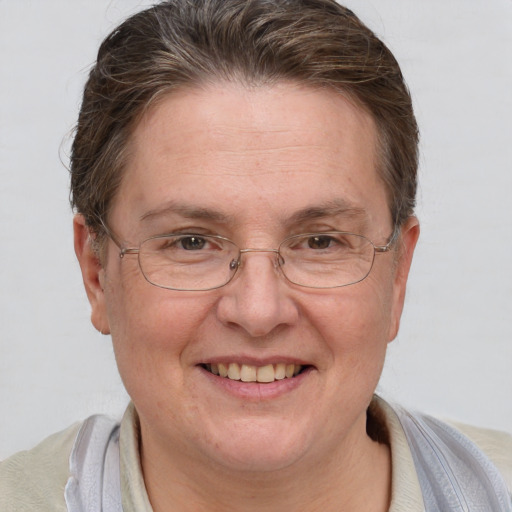 Joyful white middle-aged female with short  brown hair and grey eyes