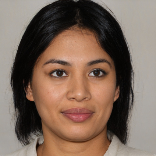 Joyful latino young-adult female with medium  black hair and brown eyes