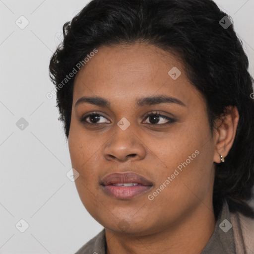 Joyful black young-adult female with long  brown hair and brown eyes