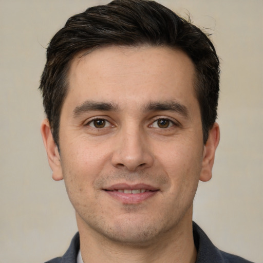 Joyful white young-adult male with short  brown hair and brown eyes